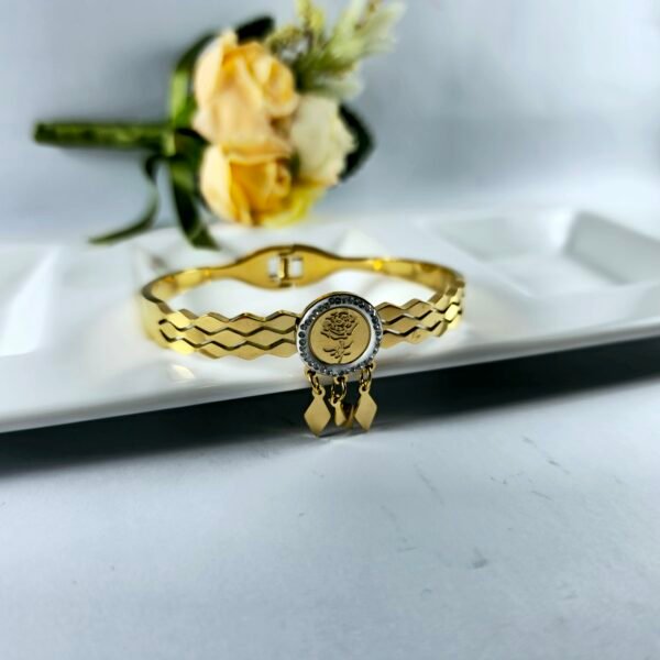 Luxurious Gold-Plated Bracelet with Intricate Rose Emblem & Dangling Charms